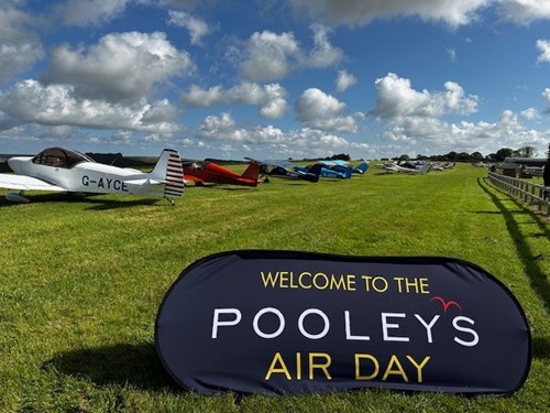 Pooleys Air Day banner with aircraft in the background